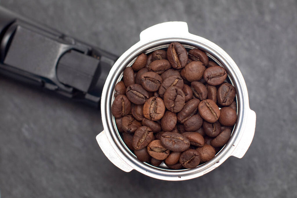 Coffee holder with coffee beans on blacke slate board. Top view - Photo, Image