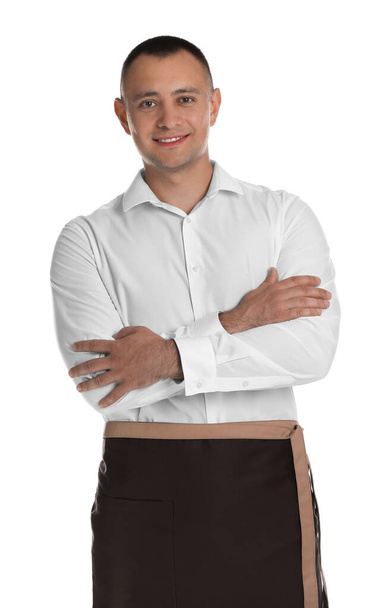 Portrait of happy young waiter in uniform on white background - Foto, Imagem