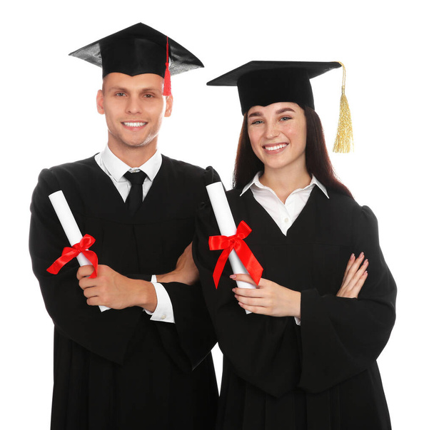 Happy students in academic dresses with diplomas on white background - Photo, Image