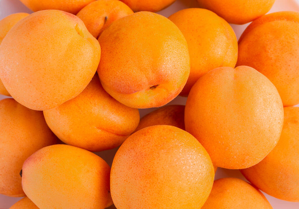 Fruit background from ripe bright apricots. - Foto, Bild