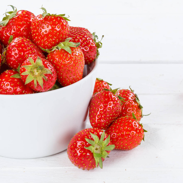 Strawberries berries fruits strawberry berry fruit in a bowl on wooden board square food - 写真・画像