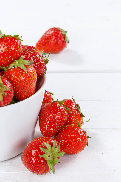 Strawberries berries fruits strawberry berry fruit in a bowl on wooden board portrait format food - Фото, зображення