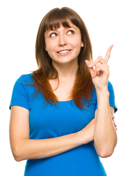 Portrait of a young woman pointing to the right - Foto, imagen