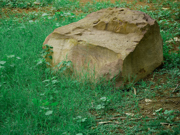 Stone piece of rock mountain presented at green grass asian park field. - Fotografie, Obrázek