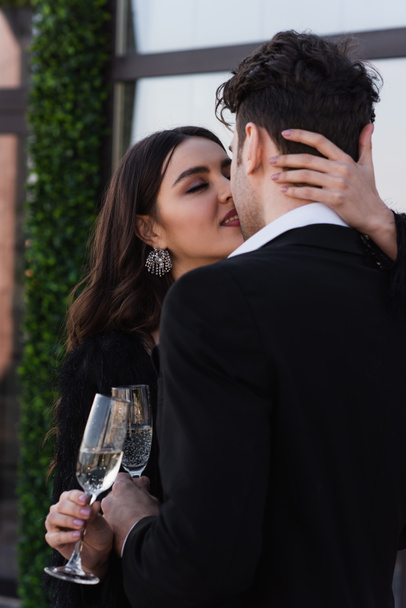 homem e mulher clinking copos de champanhe e beijos fora  - Foto, Imagem