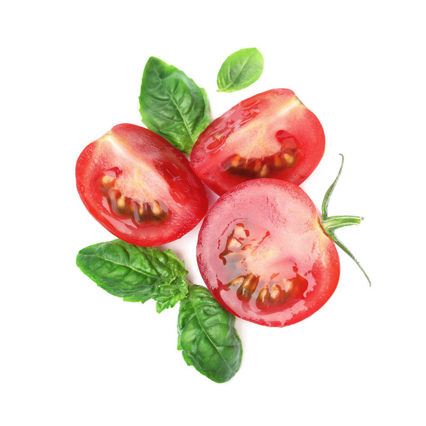 Fresh green basil leaves with cut tomato on white background, top view - Photo, Image