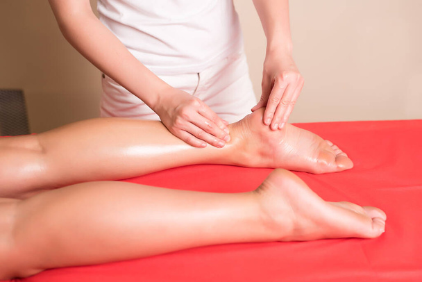 Woman foot massage in spa salon - Fotó, kép