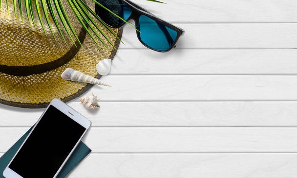 Summer vacation background with traveler accessories with seashell and palm leaf. Top view - Photo, Image