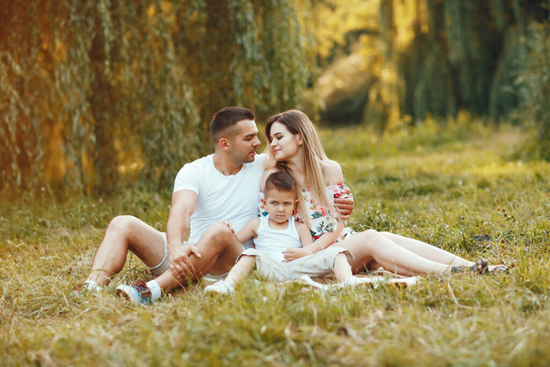 Cute family playing in a summer park - Valokuva, kuva