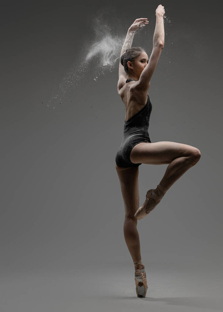 Young artistic ballerina and her professional perfomance - Photo, Image