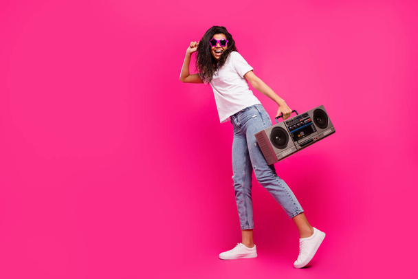 Full length body size view of pretty trendy cheerful girl holding boombox dancing isolated over shine pink fuchsia color background - Zdjęcie, obraz