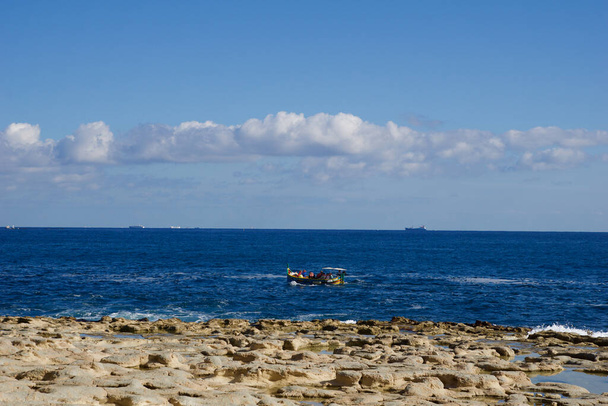 MARSAXLOKK, MALTA - 03 JAN, 2020: Traditional fishing boat in the Mediterranean Sea on the coast of Malta - Photo, Image