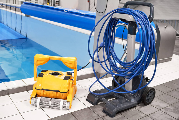 Yellow Robotic Pool Cleaner blue water pool cover - Photo, Image