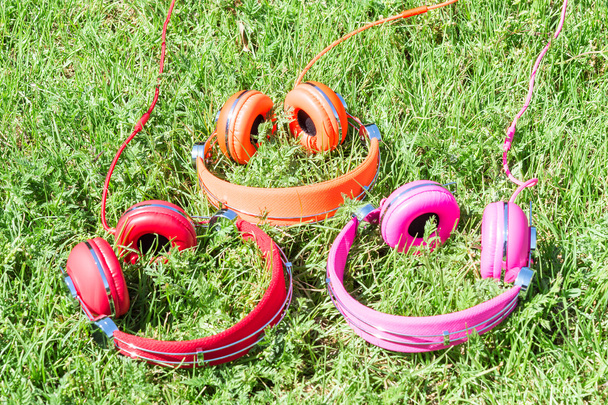 Three varicolored vibrant colorful headphones - Photo, Image