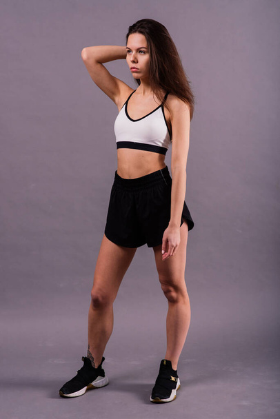 Young and beautiful dancer posing in a studio - Photo, Image