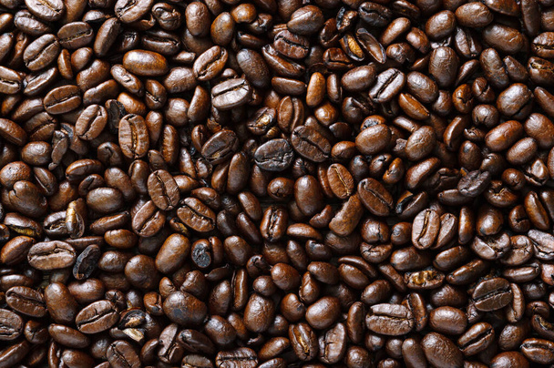 Roasted full coffee beans close-up. Coffee background. Top view, flat lay. - Фото, изображение