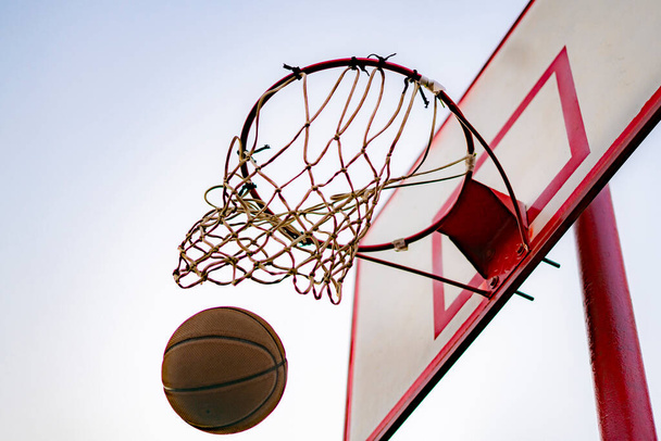 ball hit or score the basket, blue sky on the background, success concepts - Foto, imagen