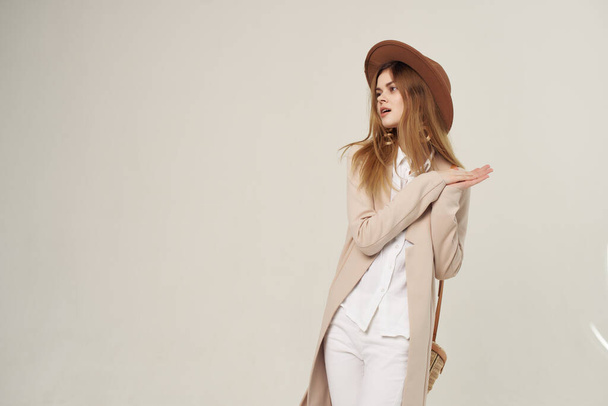 fashionable woman in hat posing in modern style luxury light background - Фото, зображення