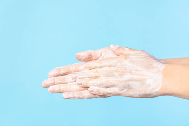 Woman washing hands with soap. Closeup of female washing hands isolated - Foto, immagini