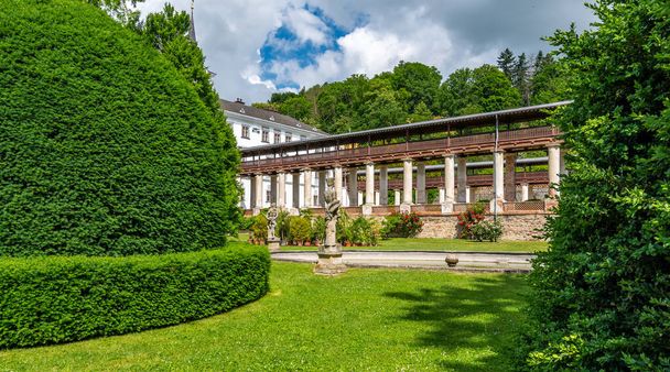 Lysice castle, Czech Republic. Famous baroque castle built in 14th century. Beautiful formal garden, palm trees and flowers. Promenade near the castle. Sunny day, dramatic clouds before storm. - Photo, image