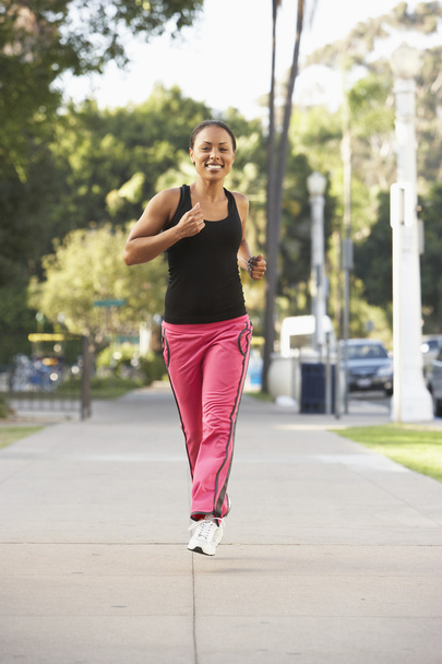 Young Woman Jogging On Street - Foto, imagen