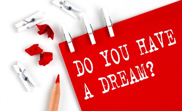 DO YOU HAVE A DREAM text on red paper with office tools on white fone - Фото, изображение