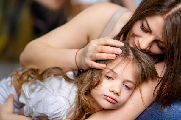 Mom cuddles with her daughter. happy family.  - Photo, image