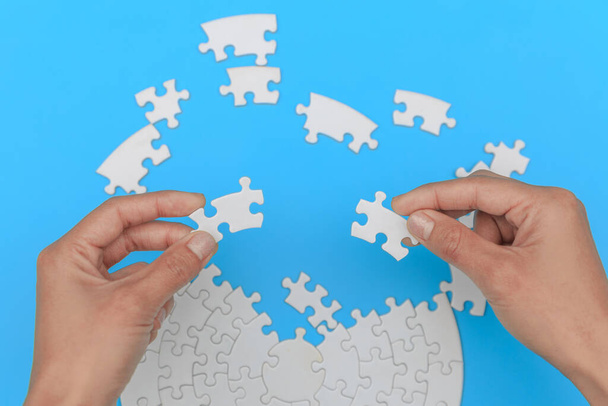 Jigsaw connection, Jigsaw puzzle in the hand of a businessman,  Business team assembling Jigsaw puzzle. - Photo, Image
