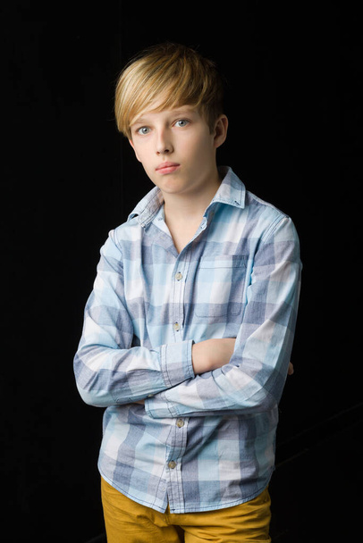 Teenage boy standing with folded hands - Фото, зображення