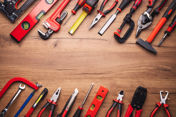 Assorted work tools on wooden background - 写真・画像