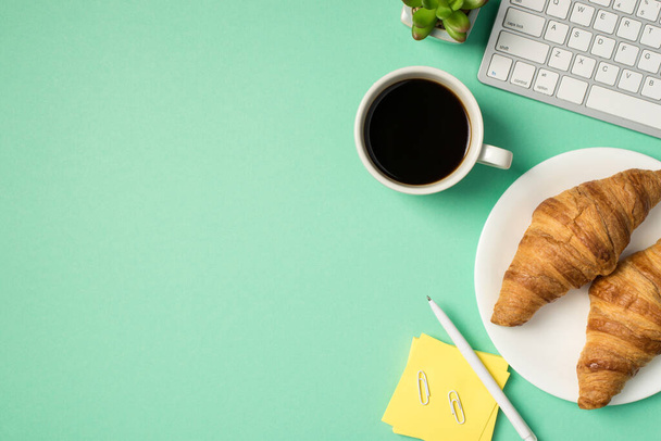 Top view photo of workplace keyboard pen clips sticky note paper flowerpot cup of coffee and two croissants on plate on isolated turquoise background with copyspace - Photo, Image