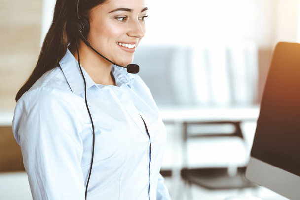 Brunette female customer service representative using headset and consulting clients online. Call center - Foto, immagini