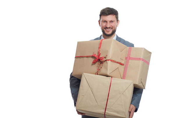 Handsome young businessman posing with presents - Foto, imagen