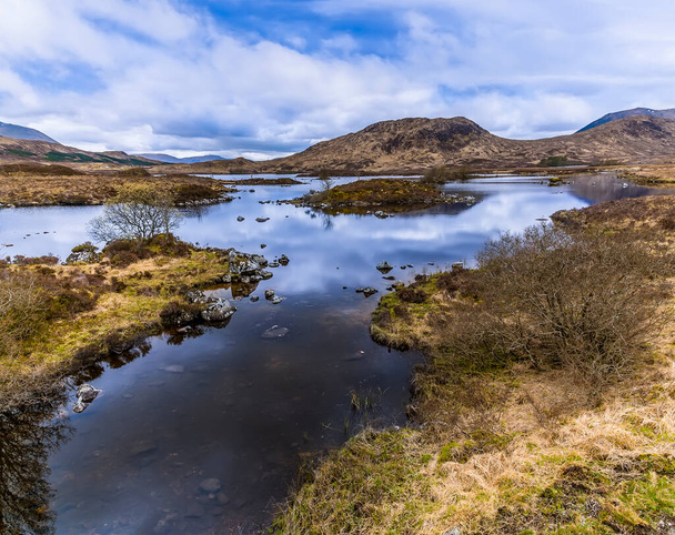 A view along a stream feeding Loch Ba near Glencoe, Scotland on a summers day - Фото, зображення