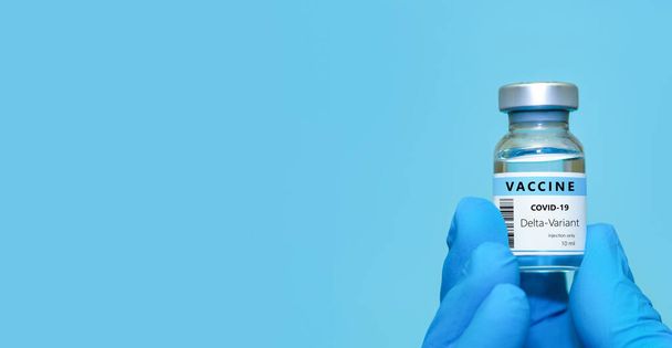 Tıbbi eldiven giyen bir doktor Coronavirus şişesi tutuyor. 19 Delta çeşidi aşısı. Tıp, sağlık ve bilim konsepti. Coronavirus aşısı. - Fotoğraf, Görsel