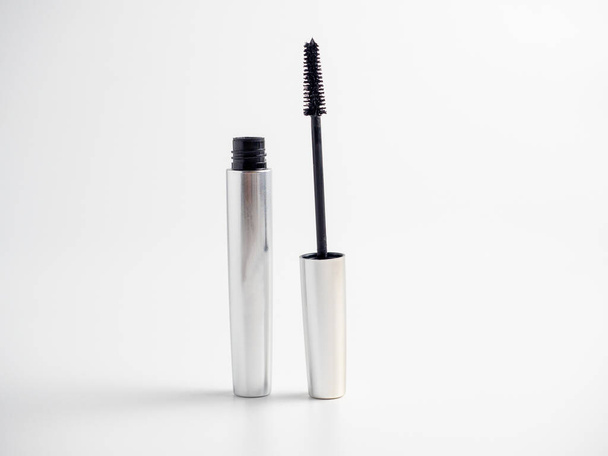 mascara in a silver tube stands on a white background. Brush for applying mascara. Cosmetology, self-care. Women's beauty - Фото, зображення