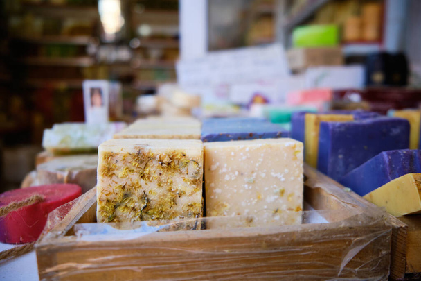Craft multi-colored natural organic soap bars at shop shelf - Zdjęcie, obraz