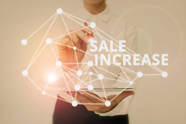 Text sign showing Sale Increase. Word Written on Average Sales Volume has Grown Boost Income from Leads Lady In Uniform Standing Holding Tablet Typing Futuristic Technologies. - Photo, Image