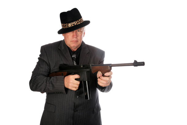 Gangster. A 1920's era gangster in a pin stripe suit holds his Thompson sub machine gun. isolated on white. room for text. Clipping Path. WW11 production .45" Thompson M1928A1 SMG with 20 round magazine. The infamous Tommy gun. Valentines Day Card.  - Photo, image