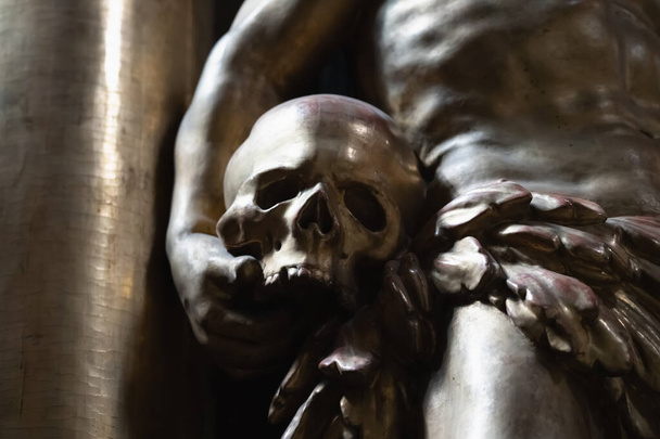 Фрагмент древней статуи Адама с человеческим черепом как символ первых людей в Эдем Райском саду.  - Фото, изображение