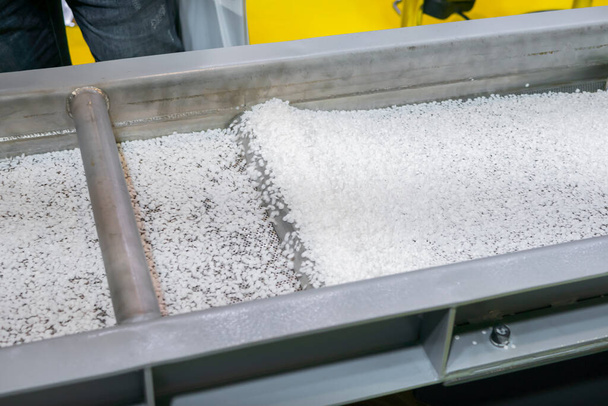 Recycled plastic granules on automatic conveyor belt, shale shaker - Photo, Image