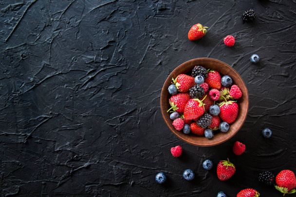 A healthy serving of fresh summer berries. Creative atmospheric decoration - Fotó, kép