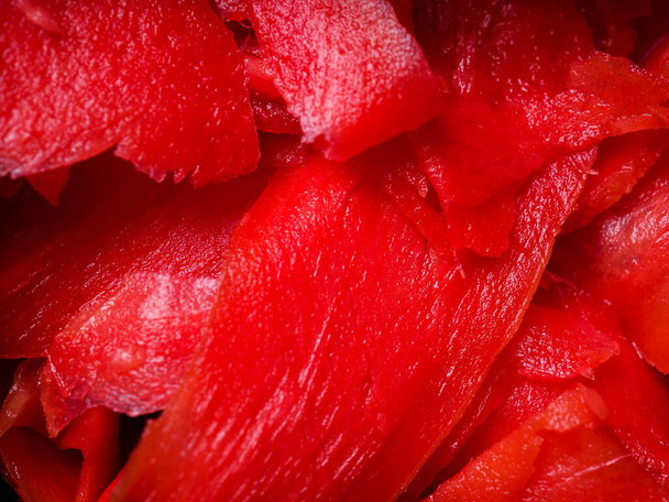 Κοντινό πλάνο κόκκινων κομματιών φρέσκου πιπερόριζας - Φωτογραφία, εικόνα