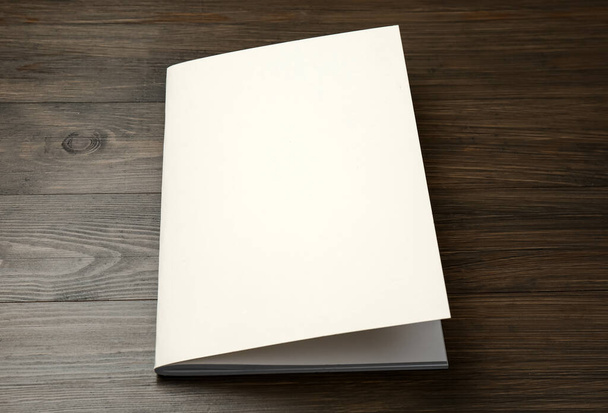Blank paper brochure on wooden table. Mockup for design - Foto, afbeelding