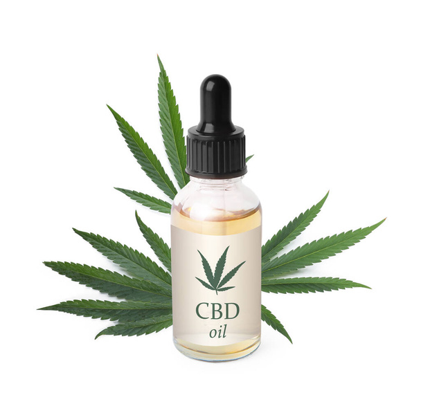 Bottle of cannabidiol tincture and hemp leaves on white background - Foto, imagen