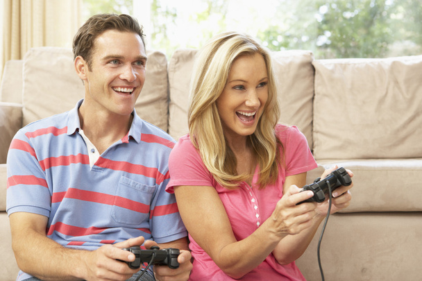 Young Couple Playing Computer Game On Sofa At Home - Photo, Image