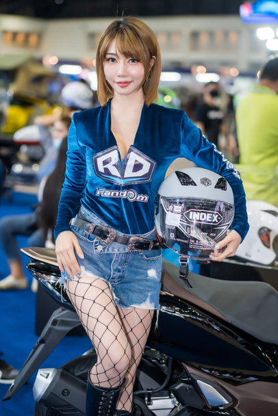 Nonthaburi, Thailand - MAR 27, 2021: Unidentified model poses with a car at The 42th Bangkok International Motor Show Thailand 2021 at IMPACT Arena, Muang Thong Thani, Nonthaburi, Thailand. - Photo, Image