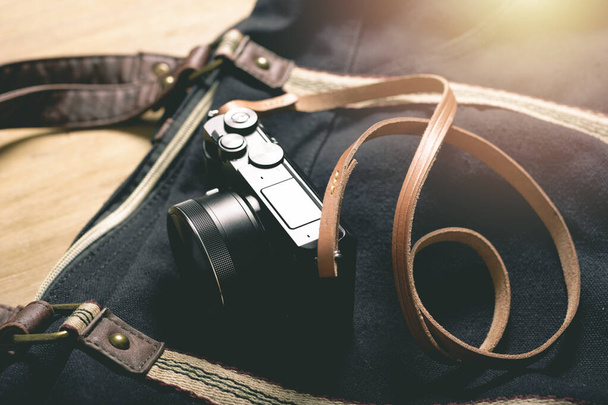 closeup vintage style of digital mirrorless camera with leather strap. - Foto, afbeelding