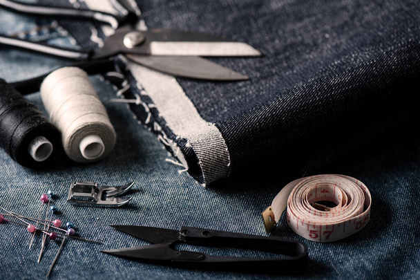 indigo denim fabric with sewing equipments, garment industrial concept. - Photo, image