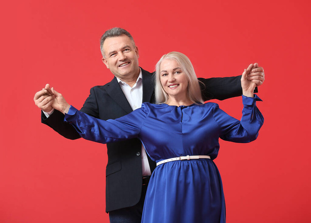 Dancing mature couple on color background - Photo, Image
